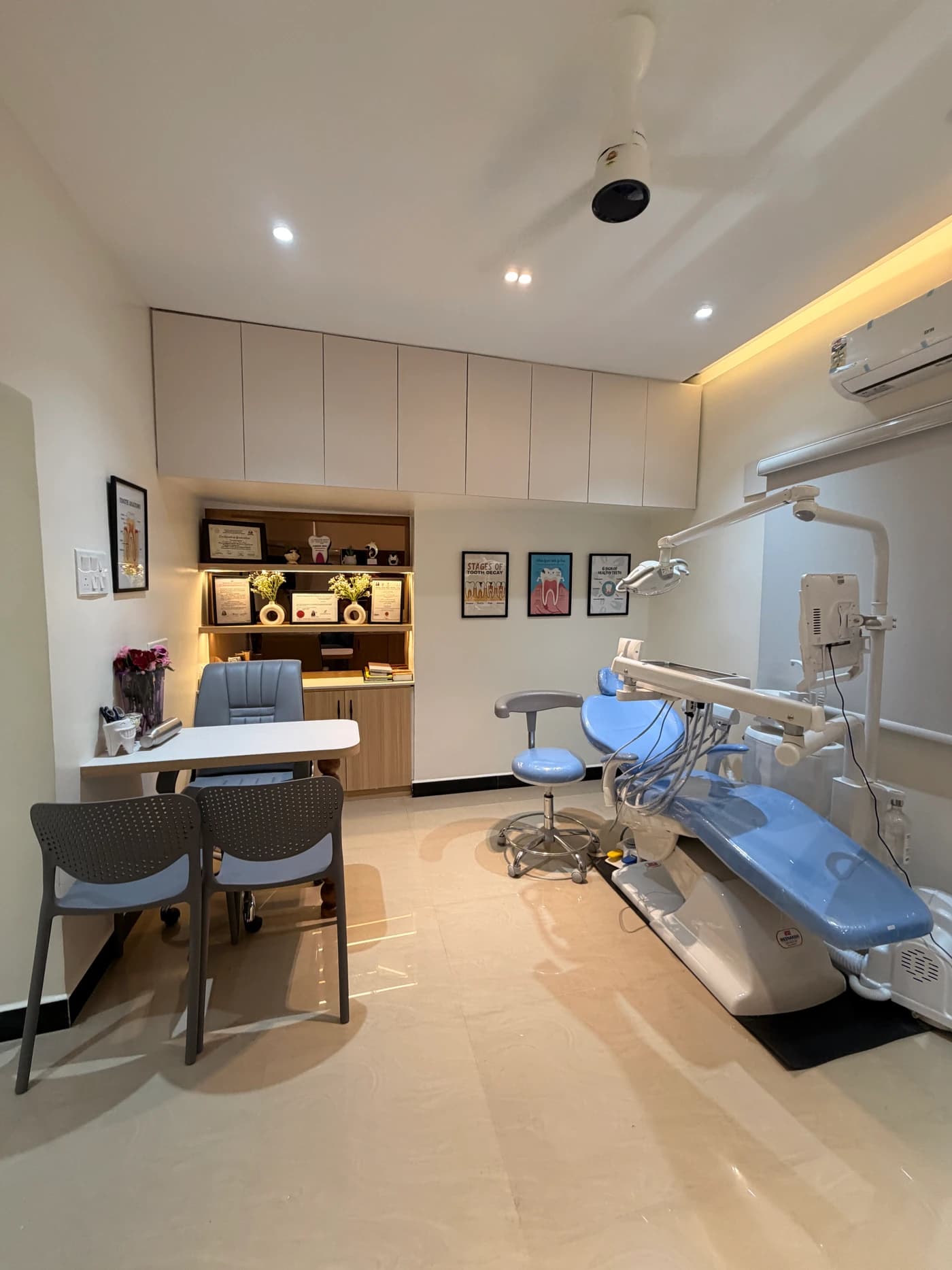 Modern dental treatment room with advanced equipment and certificates